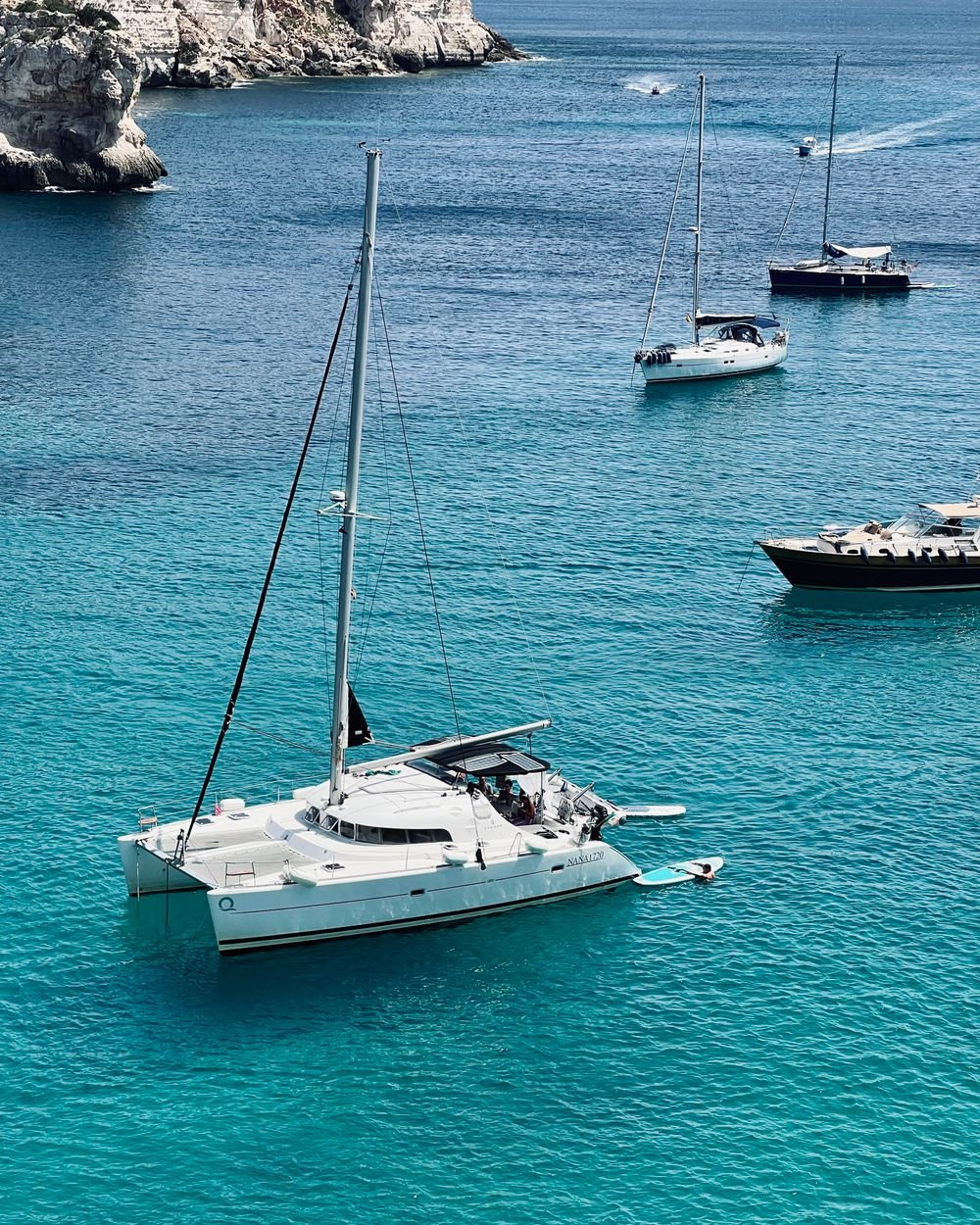 Catamaran anchored over turquoise water