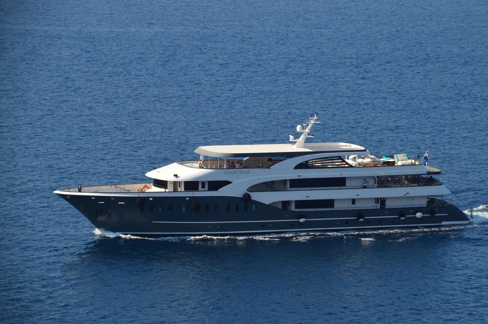 A motor yacht under way on open blue water
