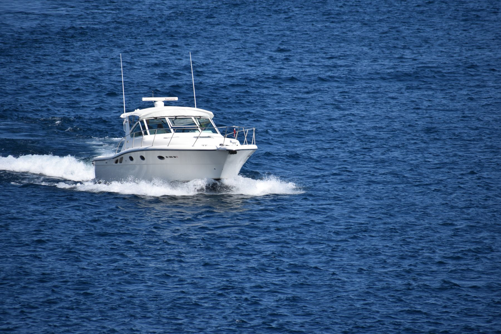 A motor yacht running along the coast