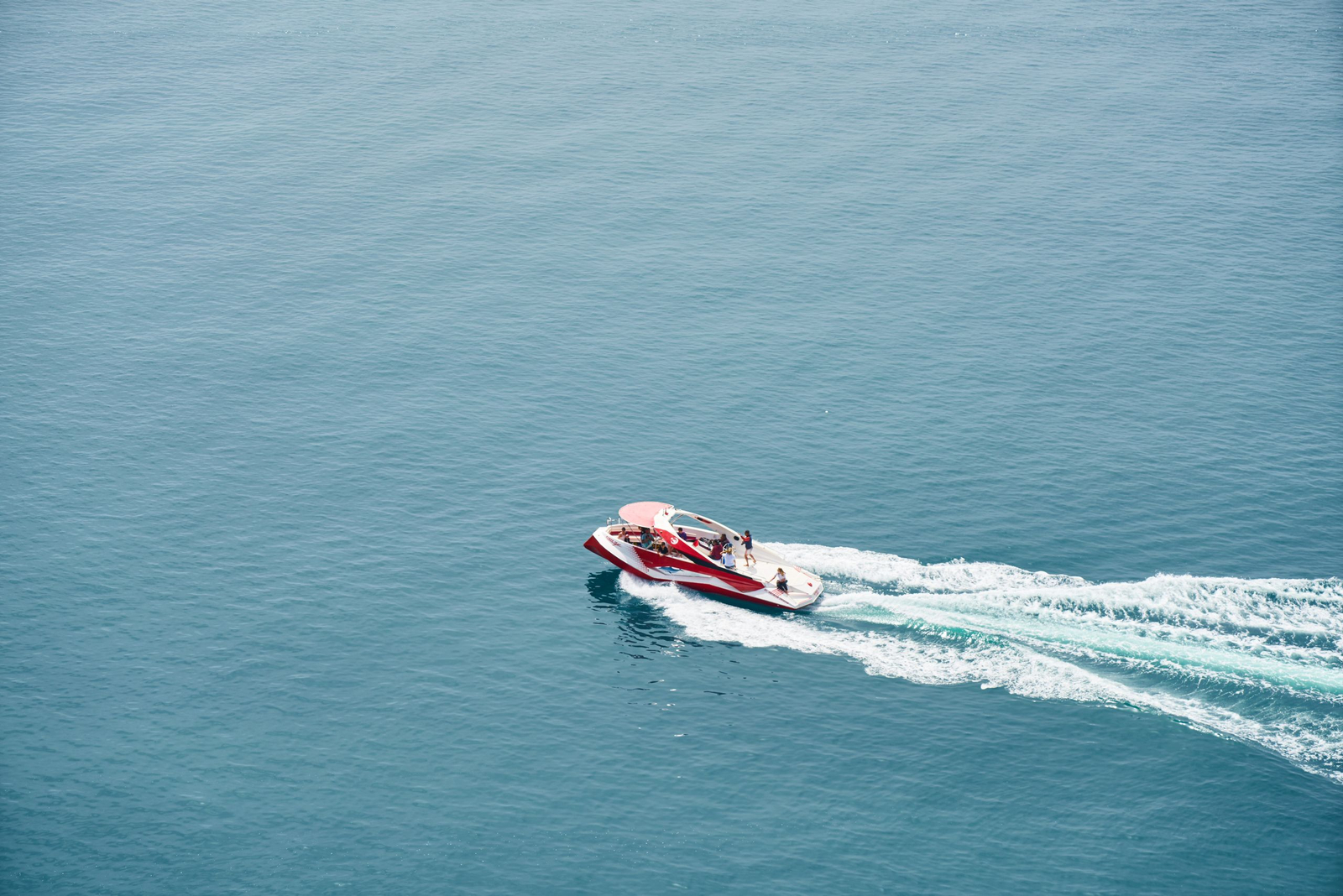 A speedboat throwing spray as it crosses the open ocean