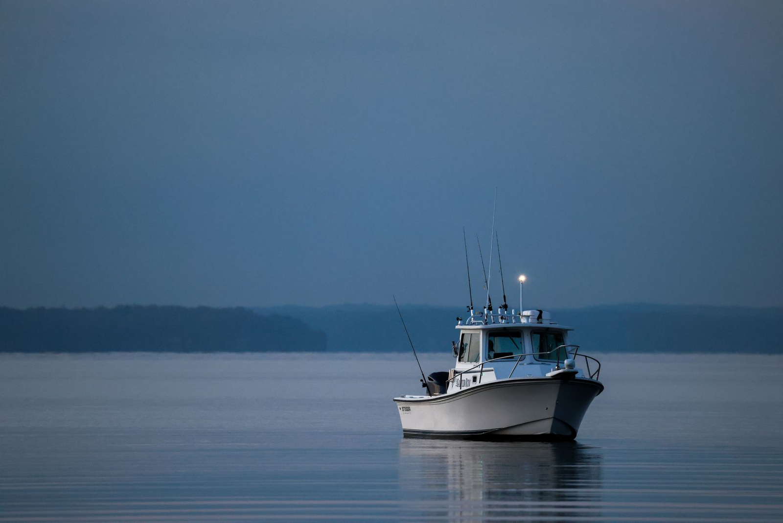A fishing boat at twilight in a quiet harbour