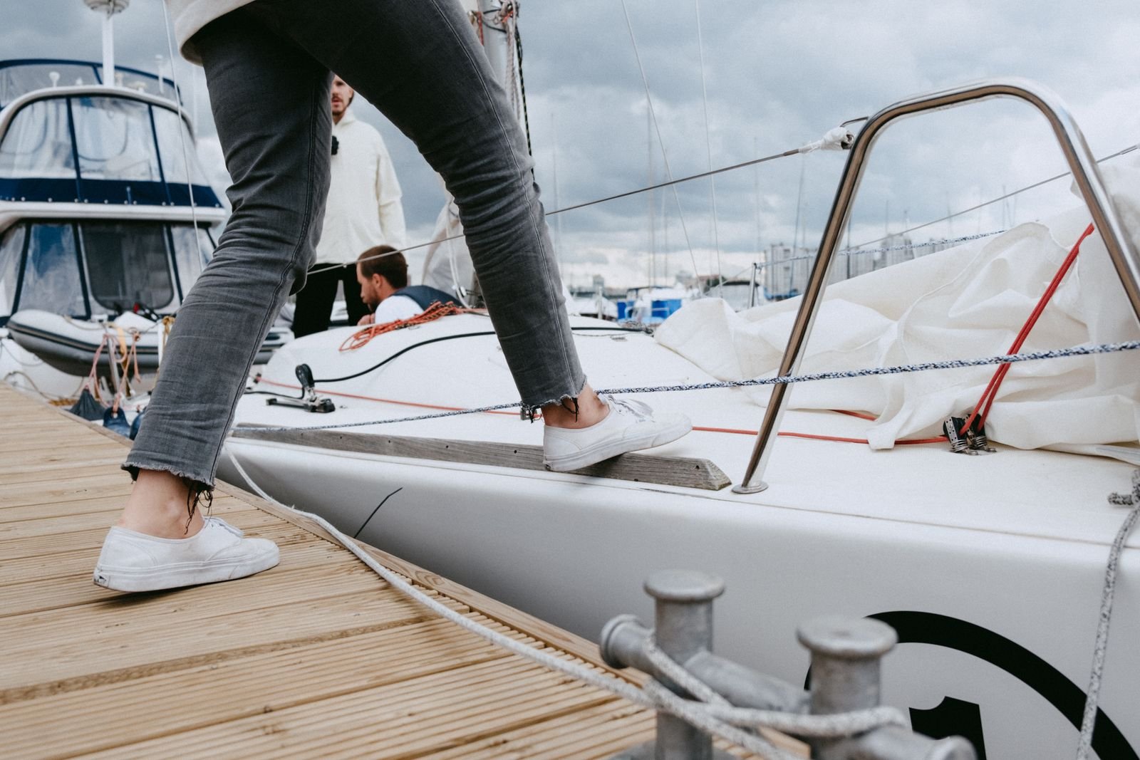 Guests stepping aboard from a marina dock