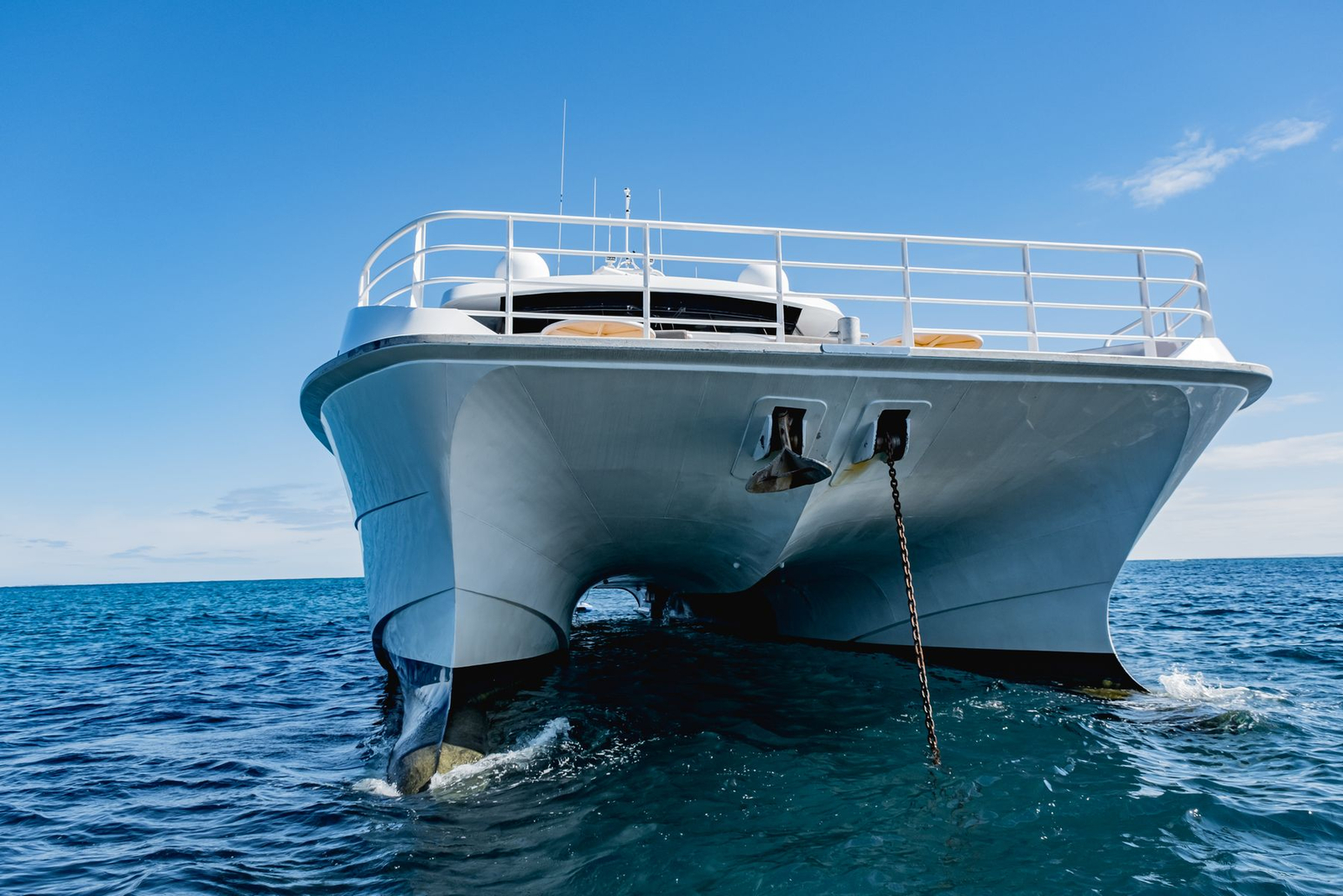 A luxury catamaran at anchor on calm turquoise water
