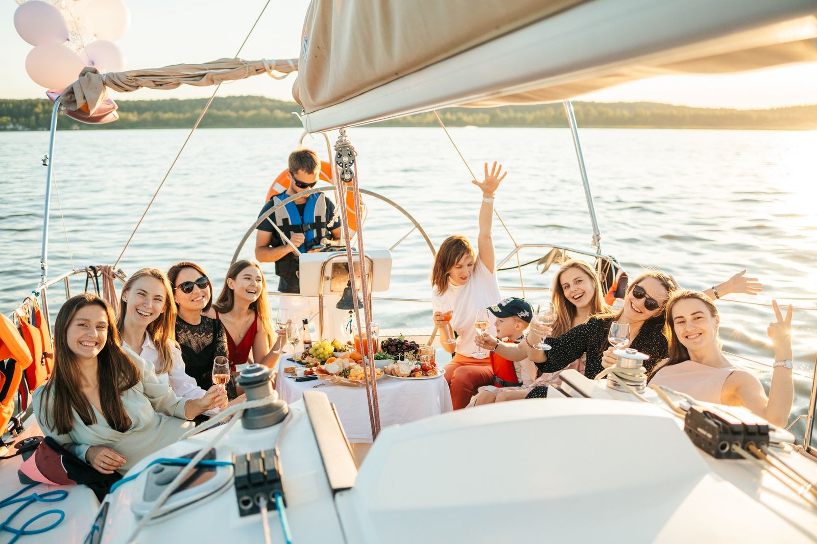 Friends celebrating together on the deck of a boat in the sun