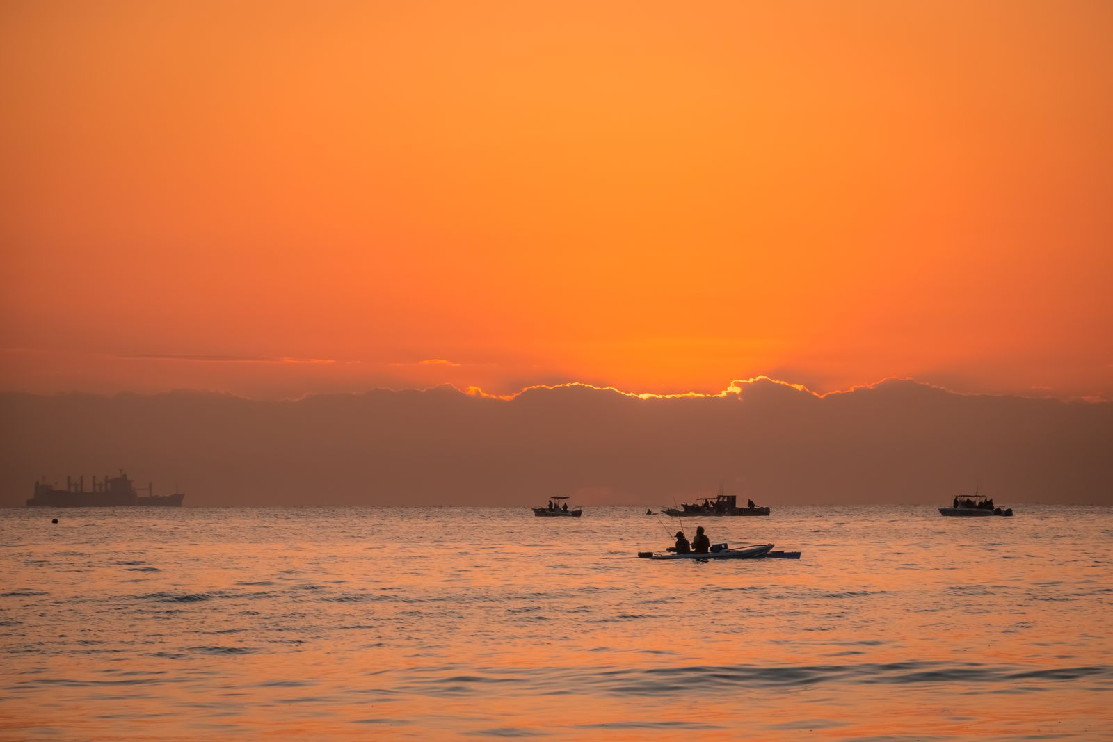 Sun dropping behind the coastline