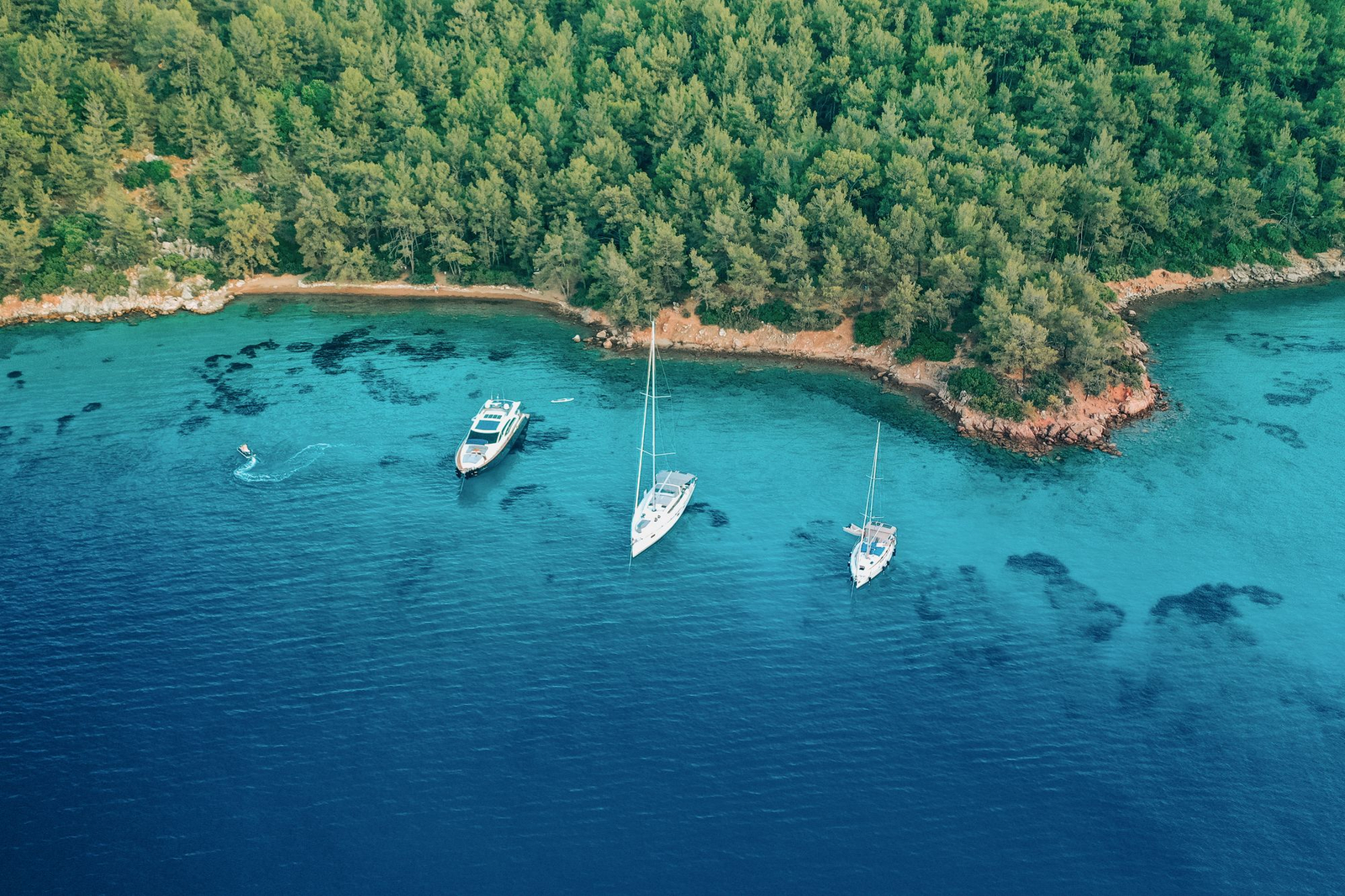Aerial of a luxury yacht above turquoise water