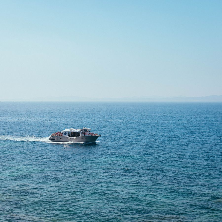 Yacht cruising past the coastline