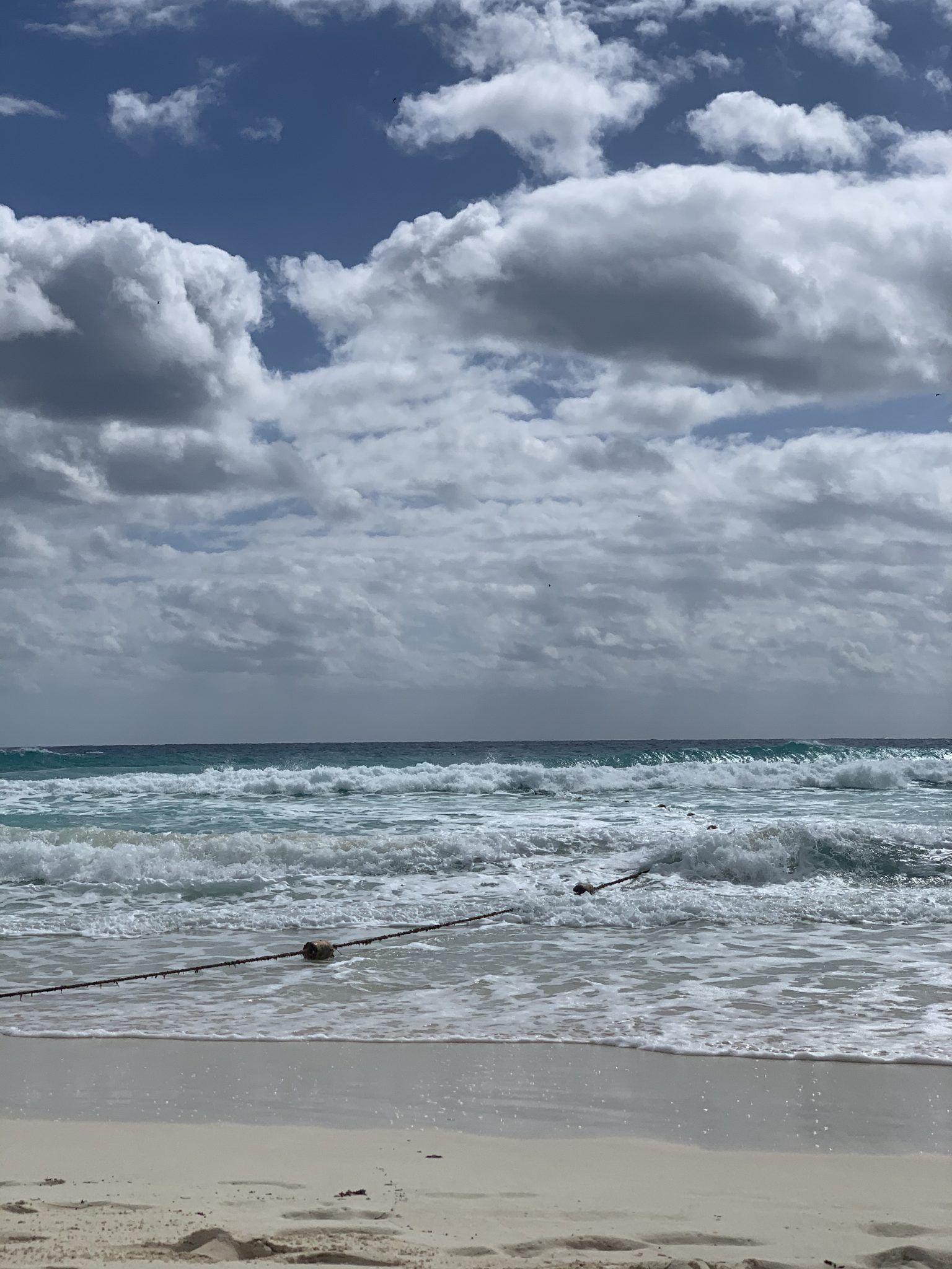 Marker buoys strung out from the shore in low surf on the Quintana Roo coast